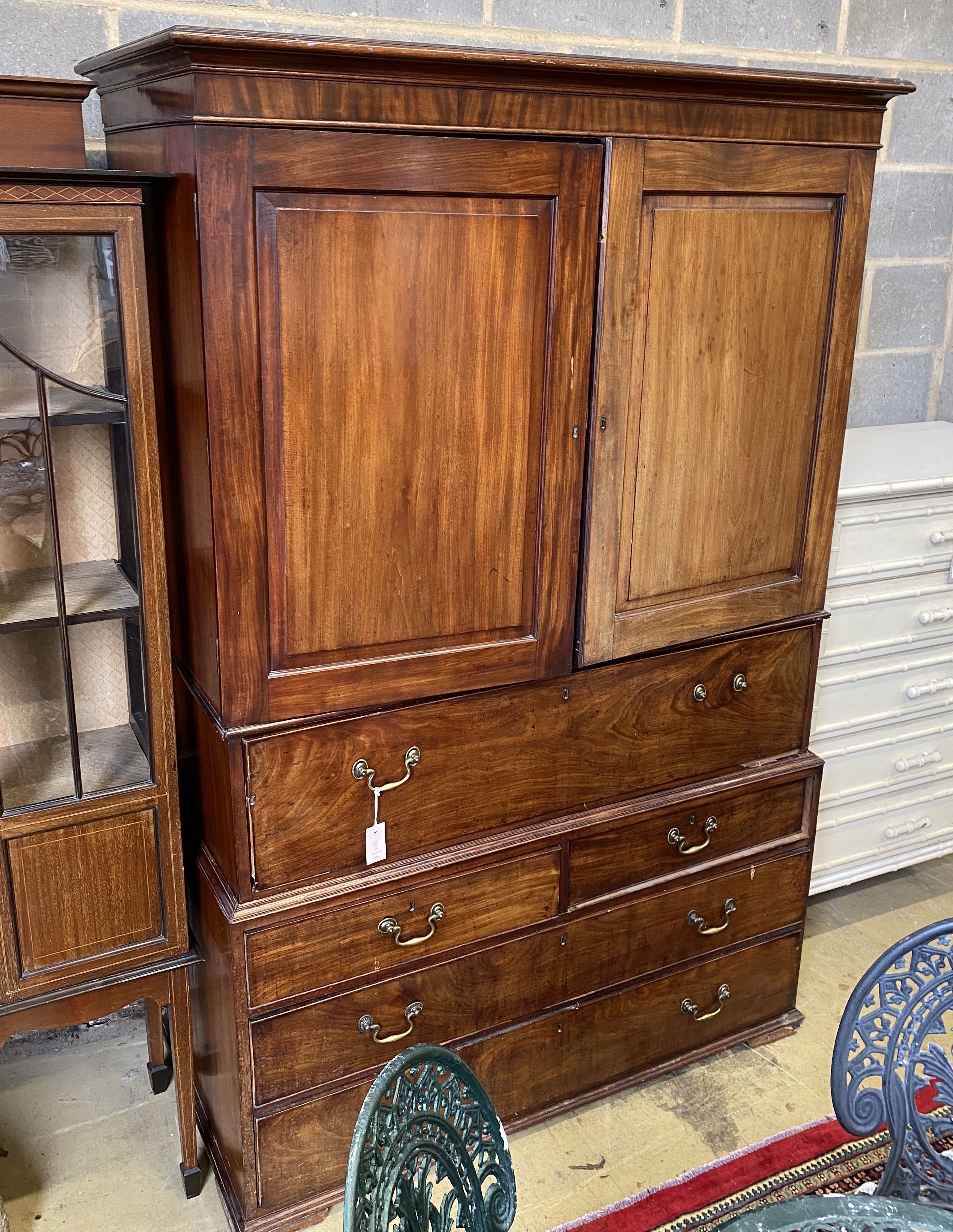 A George III mahogany secretaire linen press, width 130cm, depth 64cm, height 196cm